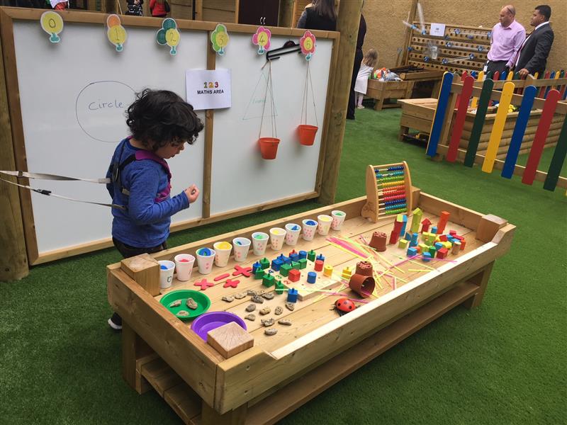 Child looking at a construction table with art and crafts materials on top