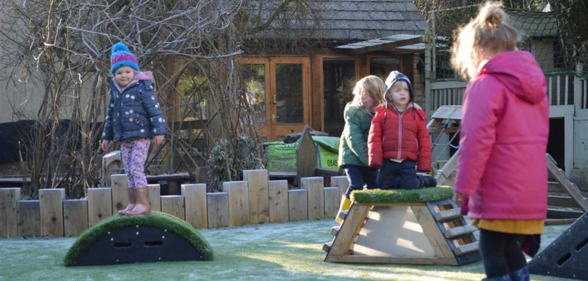 A small group of children are playing on the Get Set Go Blocks set during the Winter.