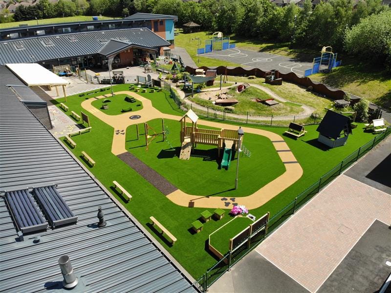 a birdseye view of the beige surfacing and green artificial grass surfacing