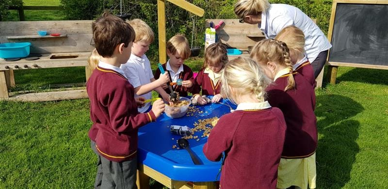 children playing with cereal on a tuff spot table 