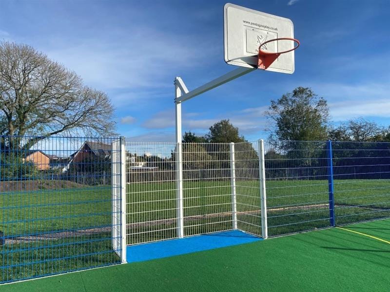 a zoomed in pic of the white and orange basketball hoop with blue surfacing below