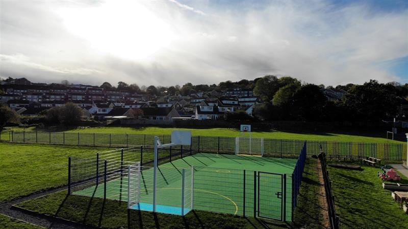 a birdseye view of the muga with the sun shining down on it