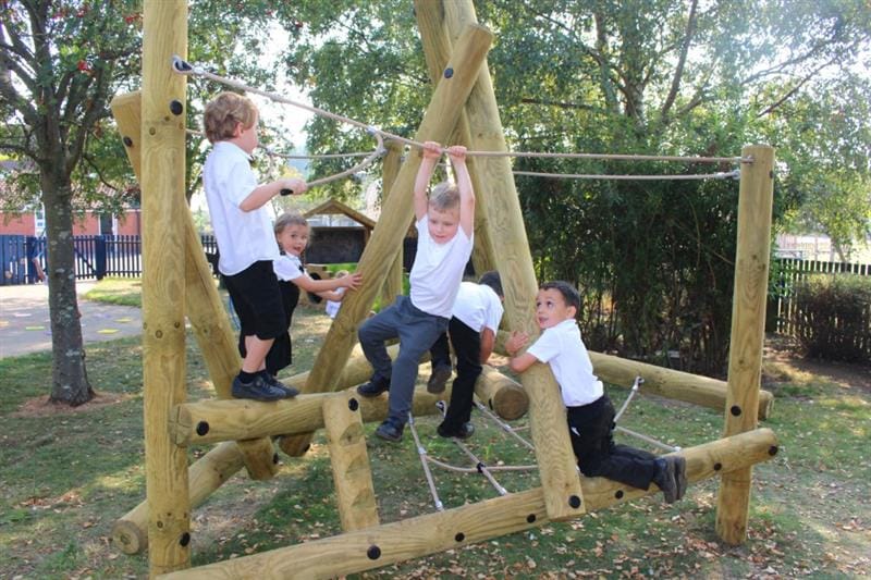 Six children in white polo shirts climbing on Pentagon Plays Harter Fell Climbing Frame
