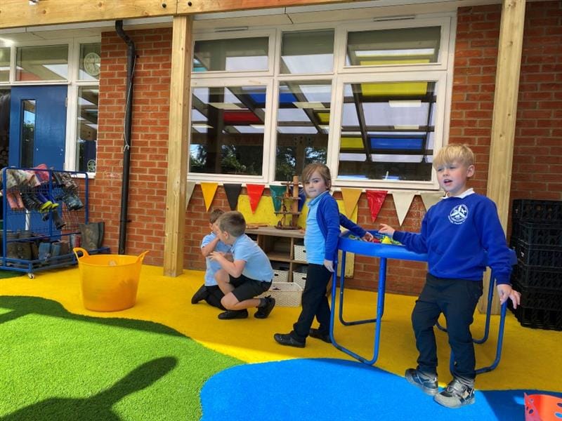 children stand on the saferturf surfacing underneath the canopy