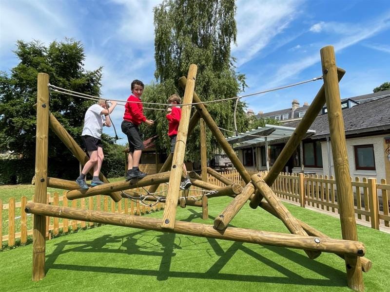 a low-level climber with children climbing on it with confidence