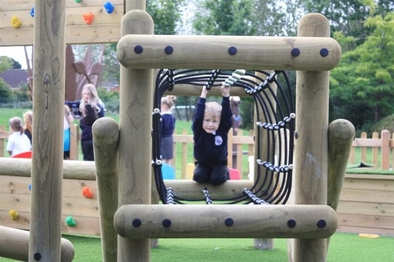 a child tries to crawl through the net tunnel