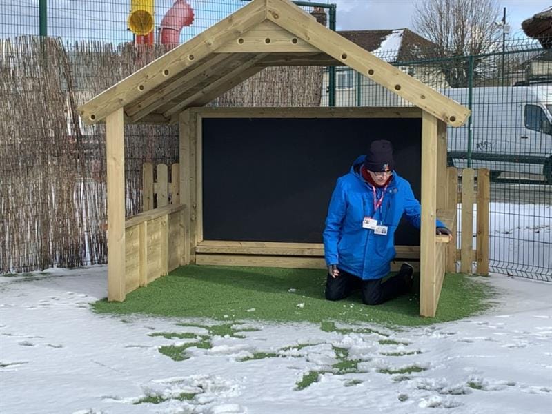 Sam inside a giant playhouse