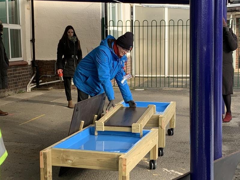 Sam showing teachers how to effectively use messy play tables on wheels