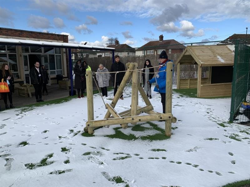 Sam showing teachers how a pinnacle hill climber improves physical development outcomes