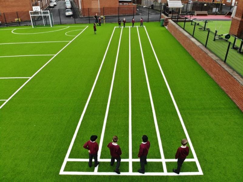 children stand on their 100m sprint track and weigh up the race