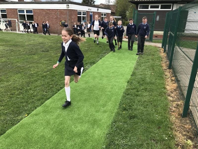 children run around the daily mile track