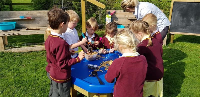 Children participating in a sensory play activities on a tuff spot table