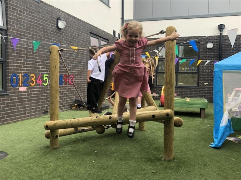 Child jumping off a climbing frame