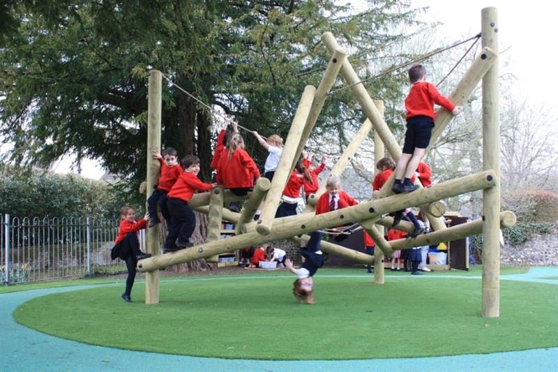 EYFS children climbing on a bowfell climber in the school playground
