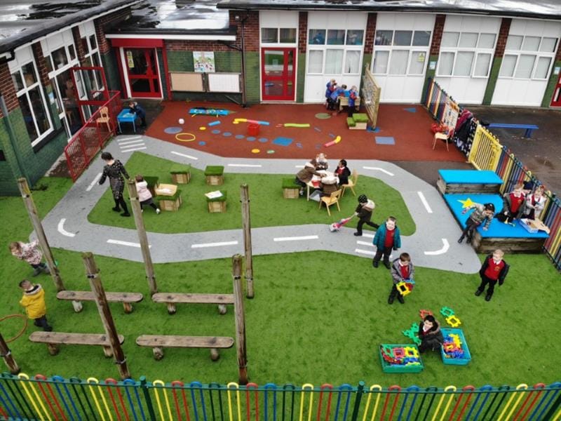 Children playing on a Pentagon Play EYFS Playground