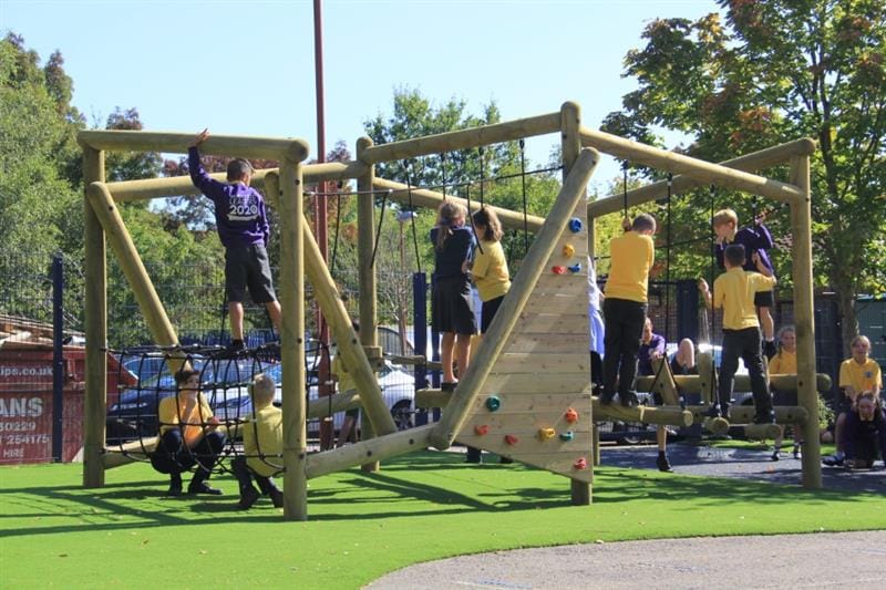 Children climbing on a school playground climbing frame
