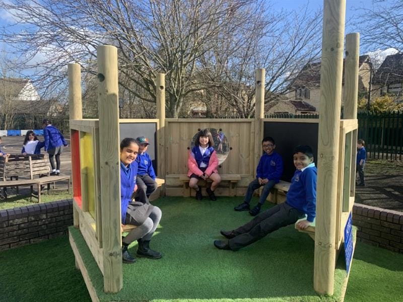 Children sitting in a playground den