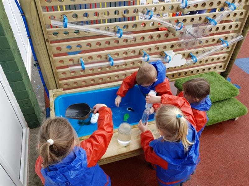 children playing in the water wall