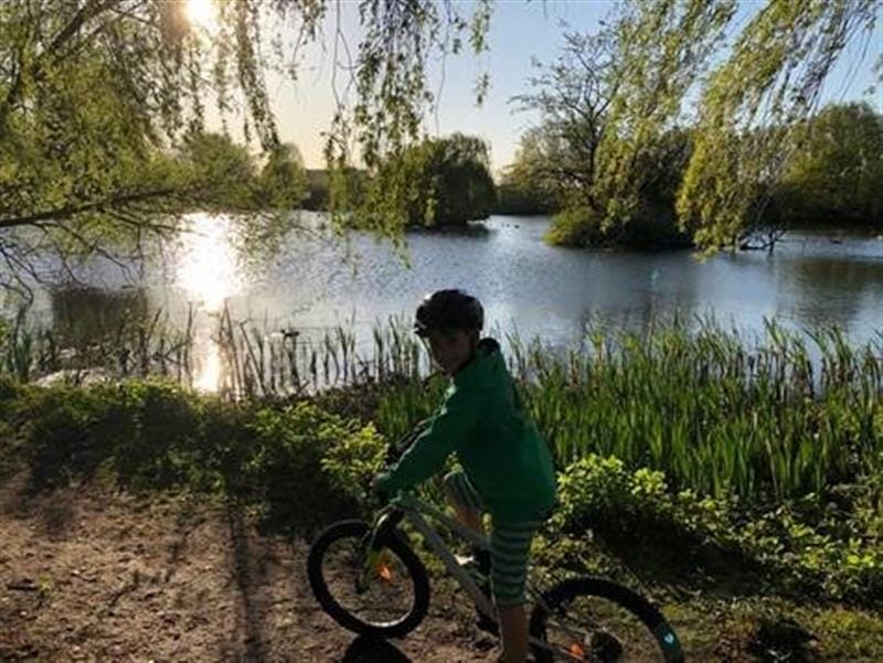 child outside on a bike exploring