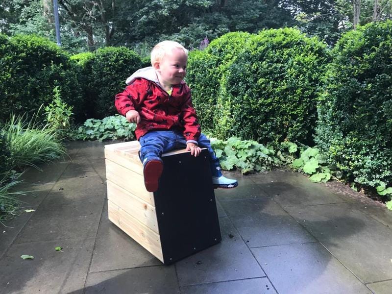 child playing on a drum seat by Pentagon Play