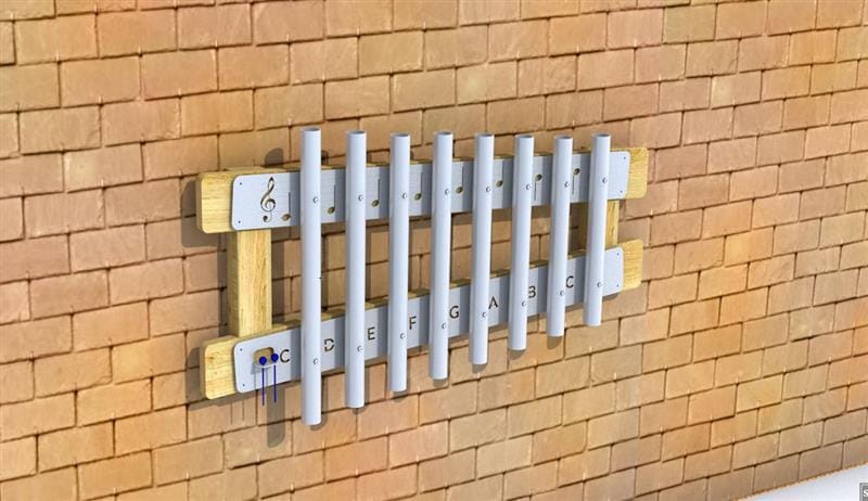 A CGI image of our Wall-Mounted Playground Chimes, showing how the product looks. The chimes are descending in height order, with the note names and a musical note engraved into the metal. Wood can be seen behind the metal, showing how the equipment is supported when it's placed on the wall.