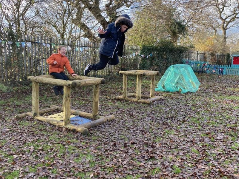 Child in mid air after jumping off an In Out Shape
