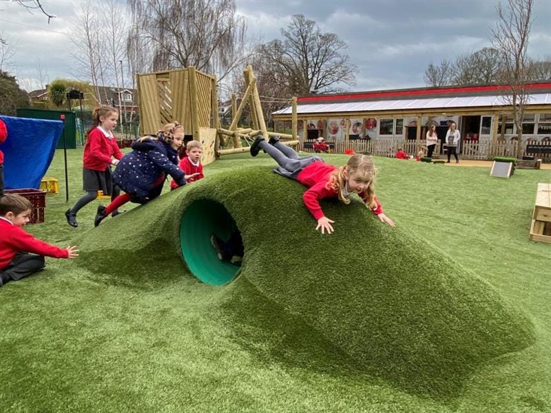 A young girl sliding down a slop on her belly