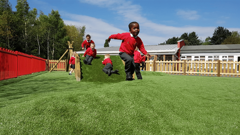 a child runs away from the climb through tunnel hill and speeds off