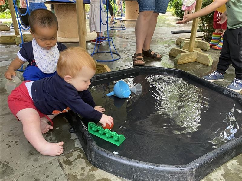 children playing on the water mat