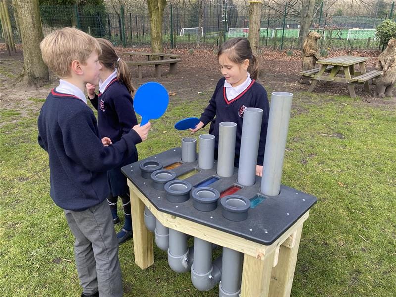 2 children using the batonka on their schools field
