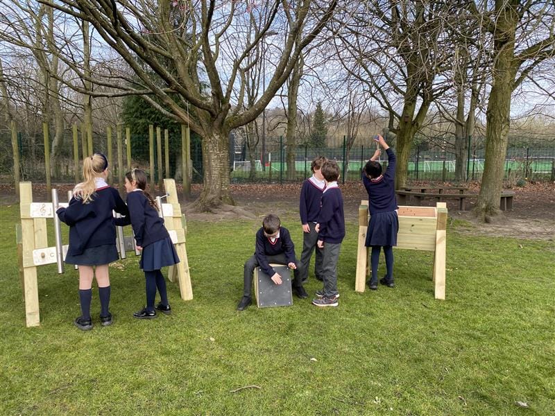 children sit on the individual items in the music pack and play music