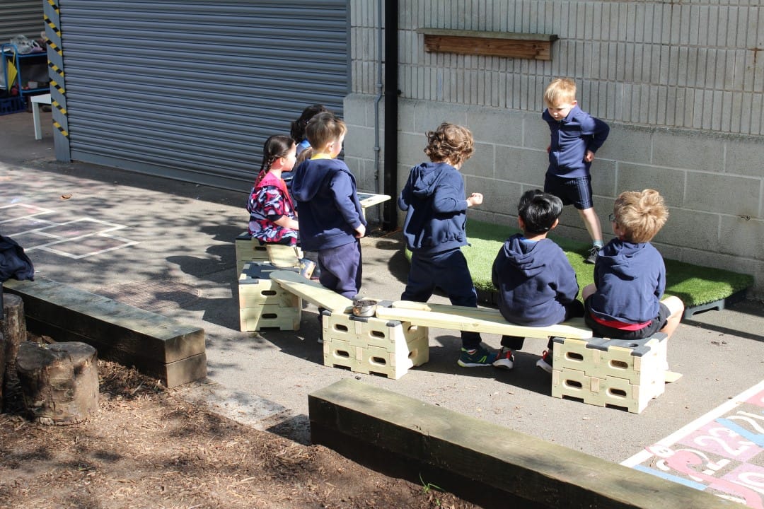 a child stand and performs for his classmates 