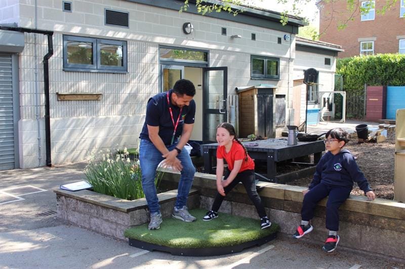 a little girl dances with our marketing director on the performance stage
