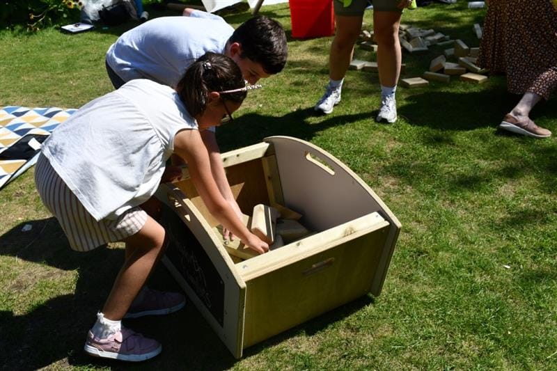 a child stands and is tidying the blocks 