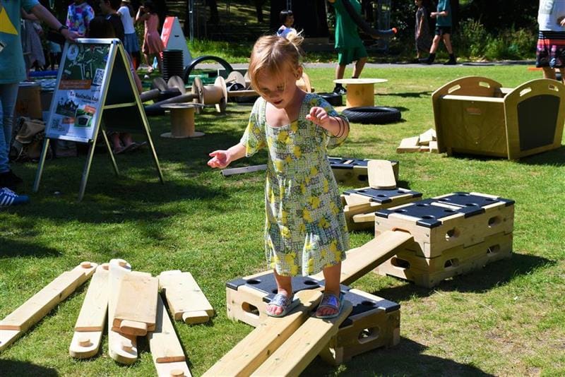 A young girl walking across the planks