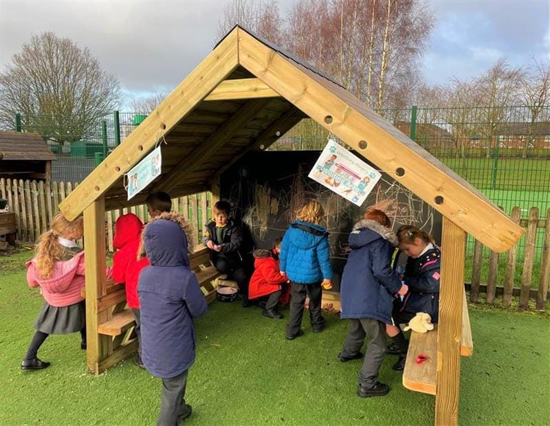 children gather inside the giant playhouse