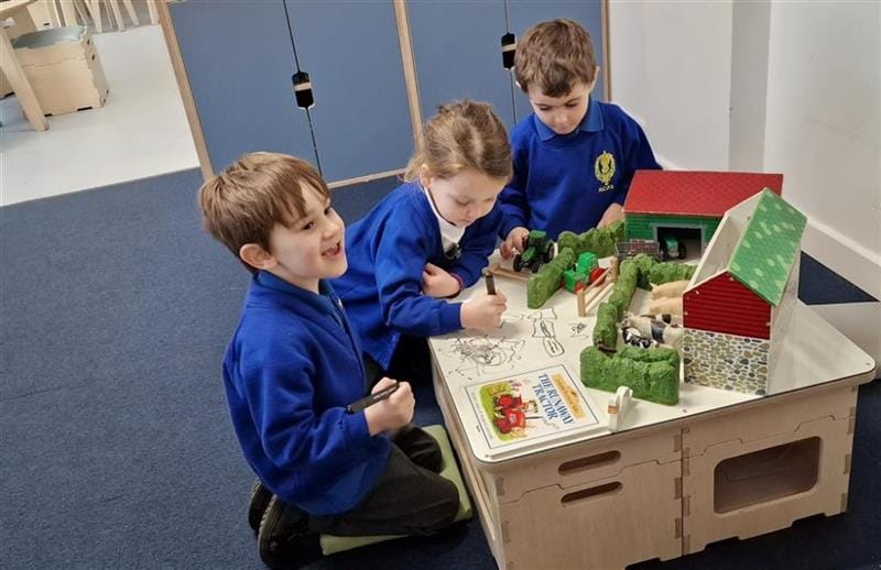 children sit around the outside of the stack and sit arrangement and play games