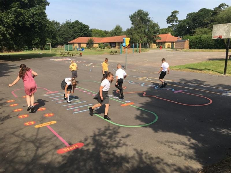 children run around on the rainbow fitness trail