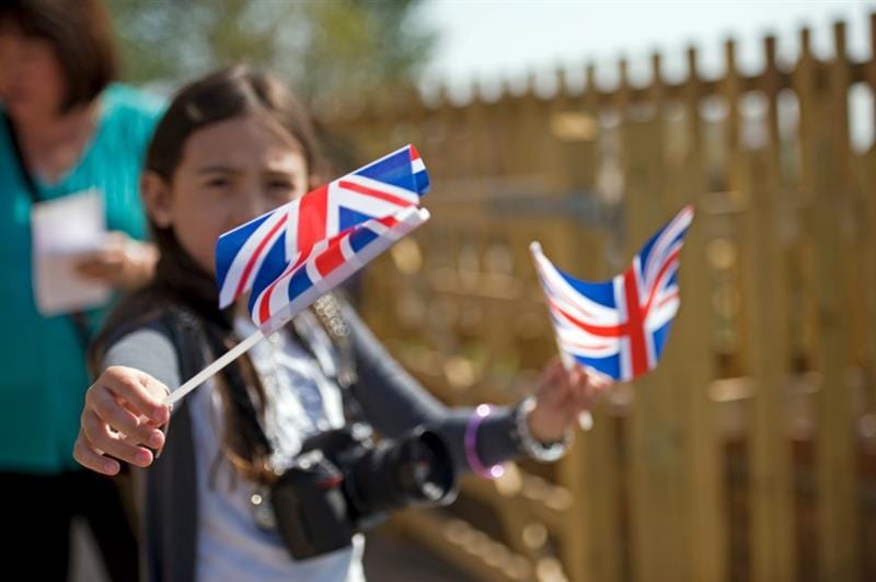 a child waves a coronation flag