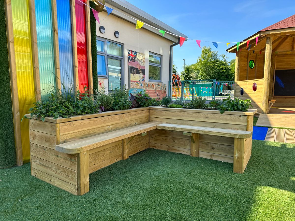 A Sensory Planter next to a Sensory Arbour on a sunny day.