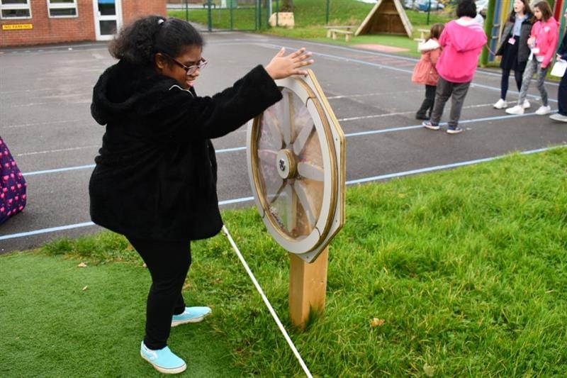 a little girl stands at the new sound sensory spinner from Pentagon Play
