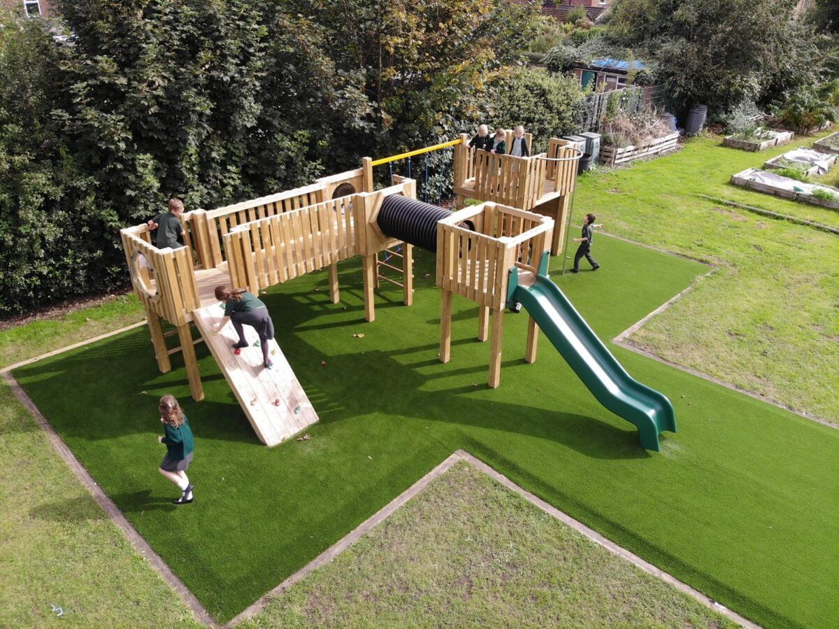 A bespoke play tower that Pentagon Play created for St Anne's Fulshaw Primary School. The picture show children engaging with the product.
