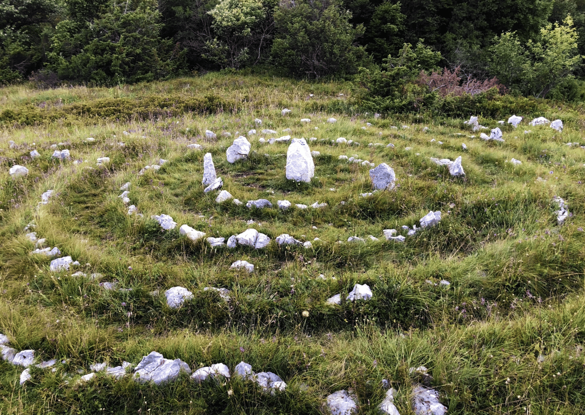 Rocks have been placed in a pattern to create some transient art. The pattern is almost like a dart board, with the rocks getting smaller from the centre