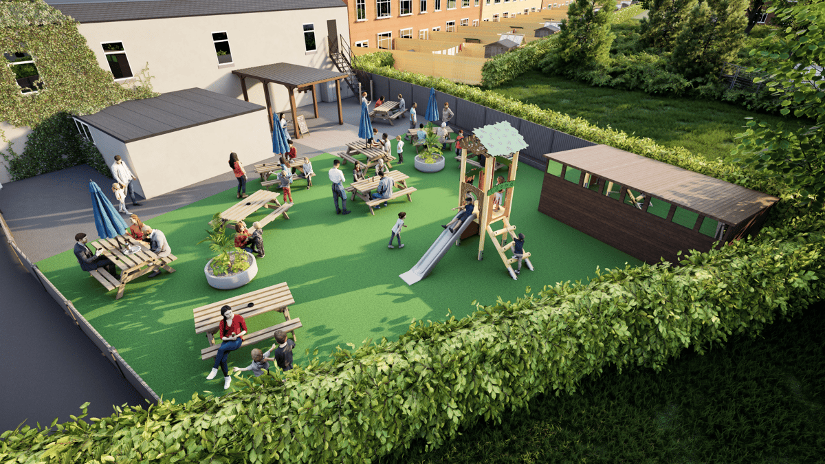 A Kestrel Play Tower that has been installed on a small play area next to a cafe. The play area has picnic benches scattered around the playground.
