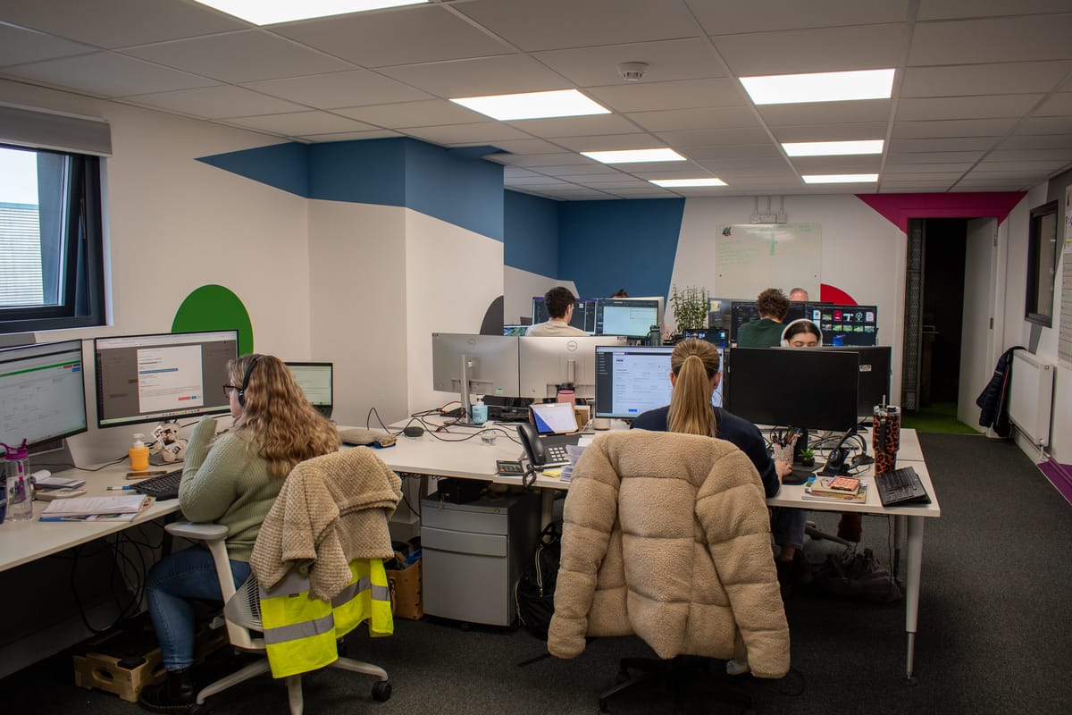 An office with a variety of different Pentagon Play employee's present, all working on helping customers with their questions