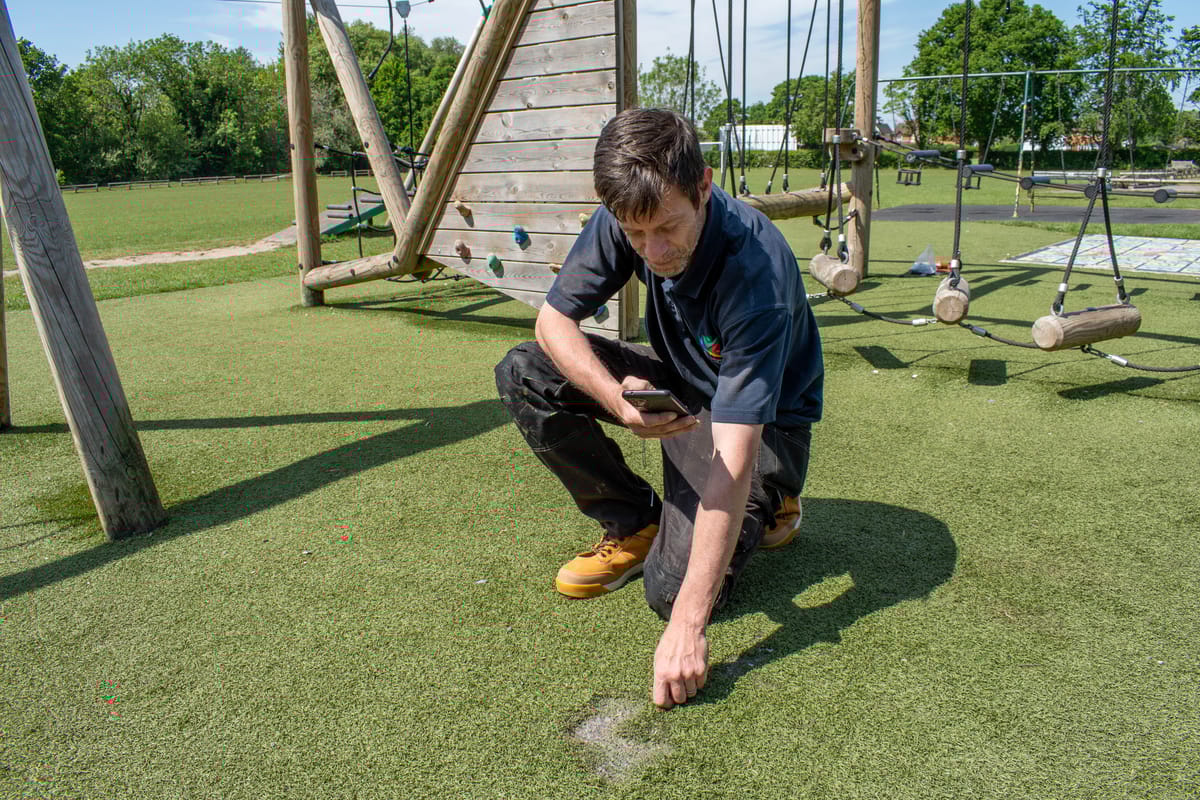 A playground inspector has discovered an area of artificial grass which has become damaged due to weeds growing within the area.