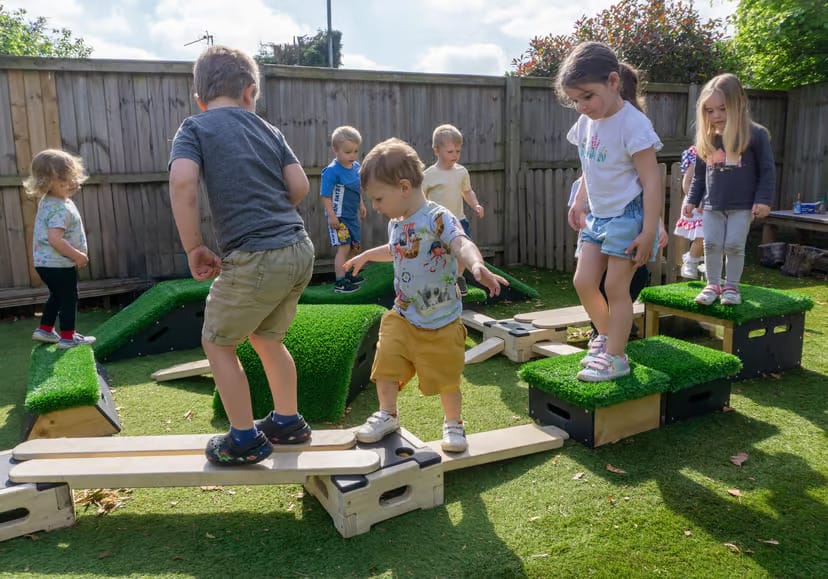 A large group of children are playing with the Play Builder and Get Set Go blocks set.