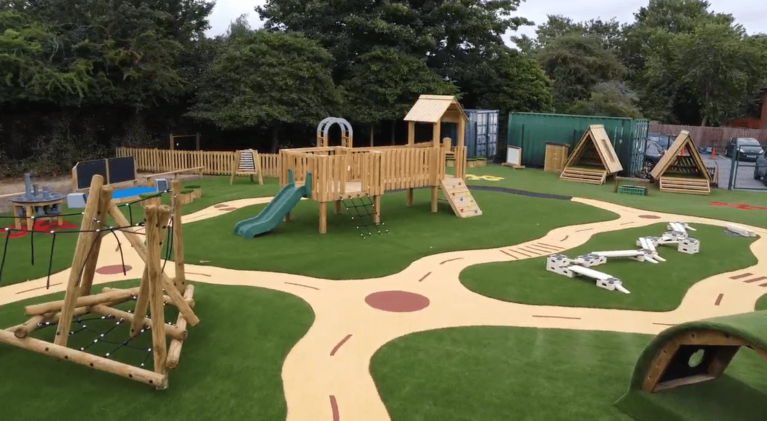A fully designed and installed playground with a variety of surfacing types and playground equipment.