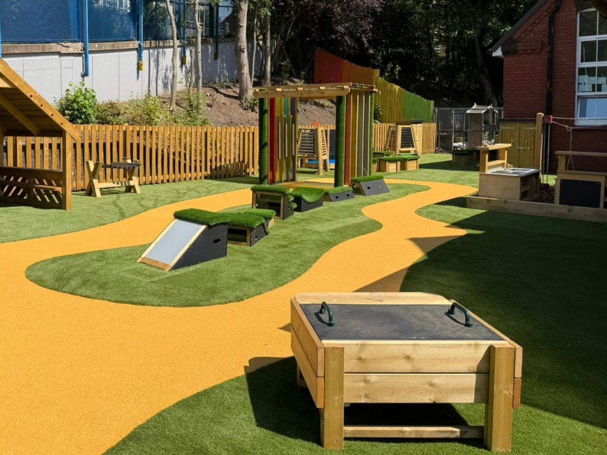 A playground with different pieces of play equipment, helping to create an inclusive environment.