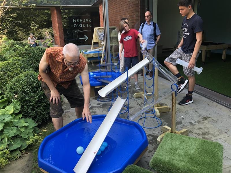 adults and children playing in our water package 